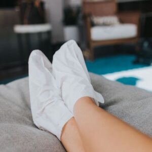 Image of feet with sock masks on cushion