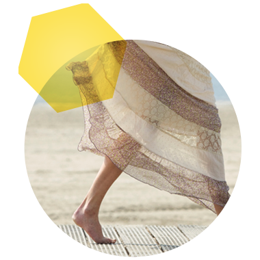 Image of legs with sheer tiered maxi skirt and walking barefoot