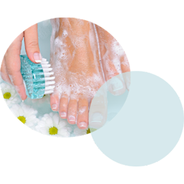 Image of scrubbing soapy feet with brush