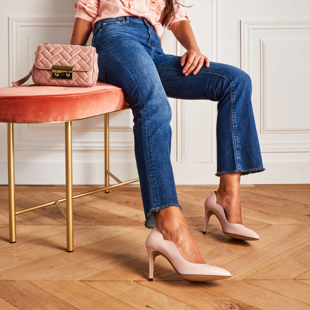 image of  a woman sitting down with high heels on